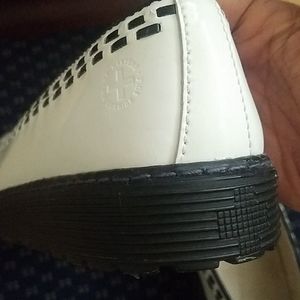 DR. Martens black stitch on white slip ons